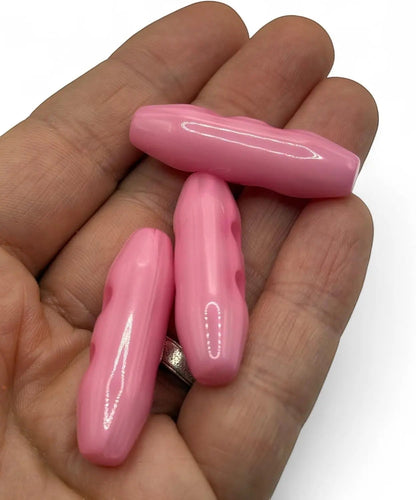 KnitForLess 38mm baby pink plastic toggle buttons with a 2-hole design held in a hand