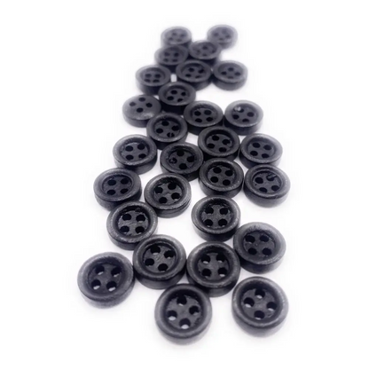 Pile of black four-hole buttons.