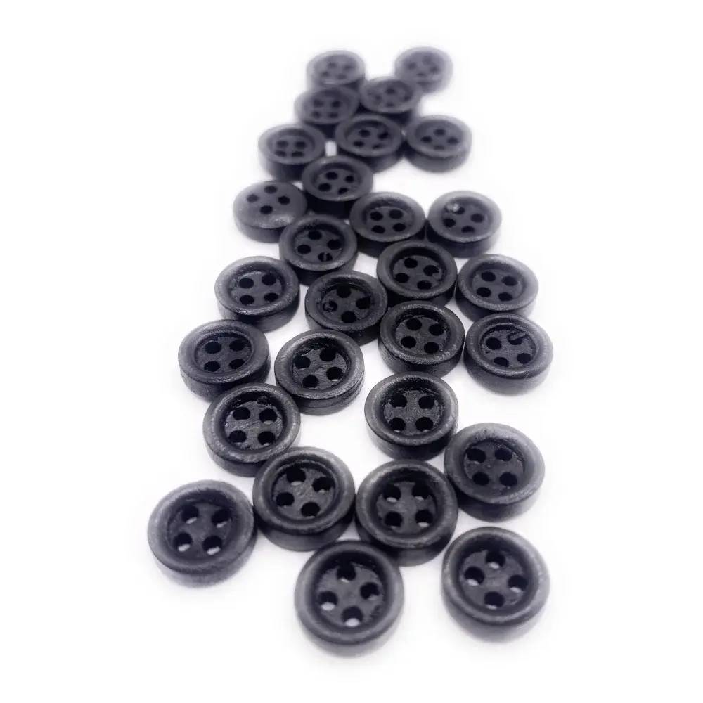 Pile of black four-hole buttons.