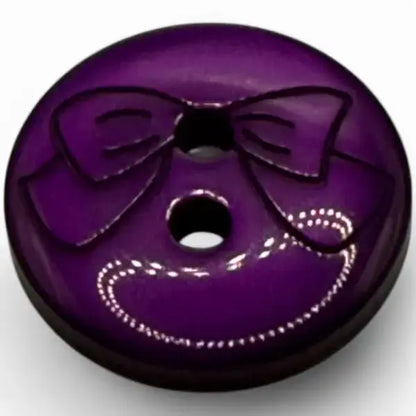 Purple button with bow design.