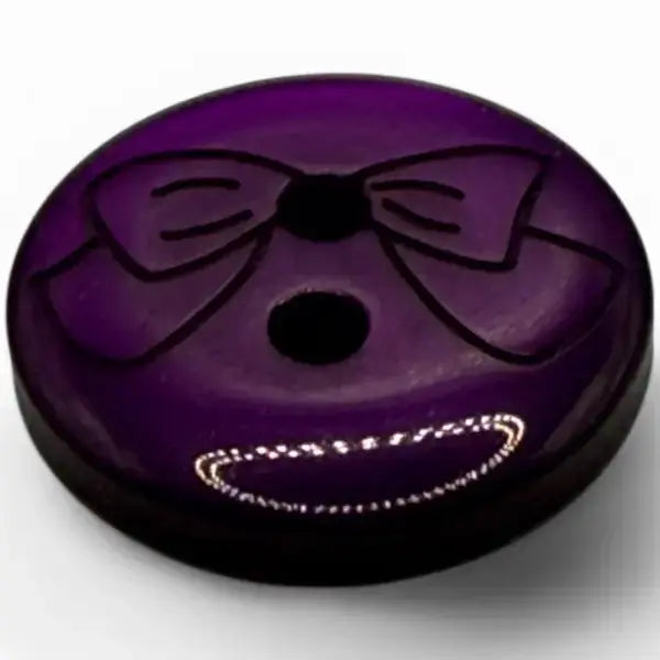 Purple button with bow design.
