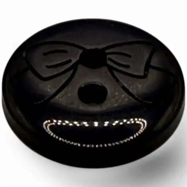Black button with a smiling face.