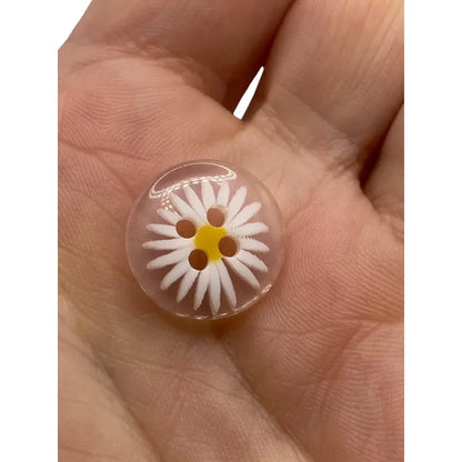 Clear button with daisy design.