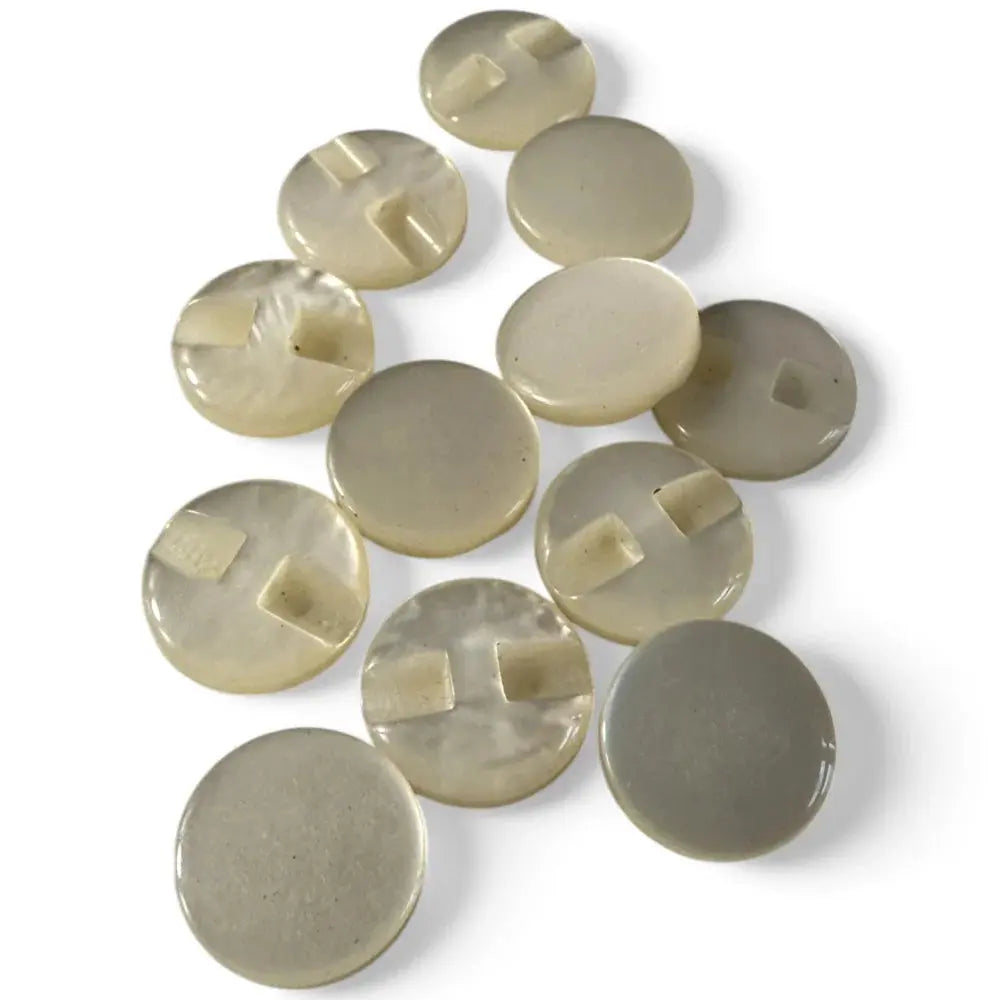 Collection of round, neutral-toned buttons.