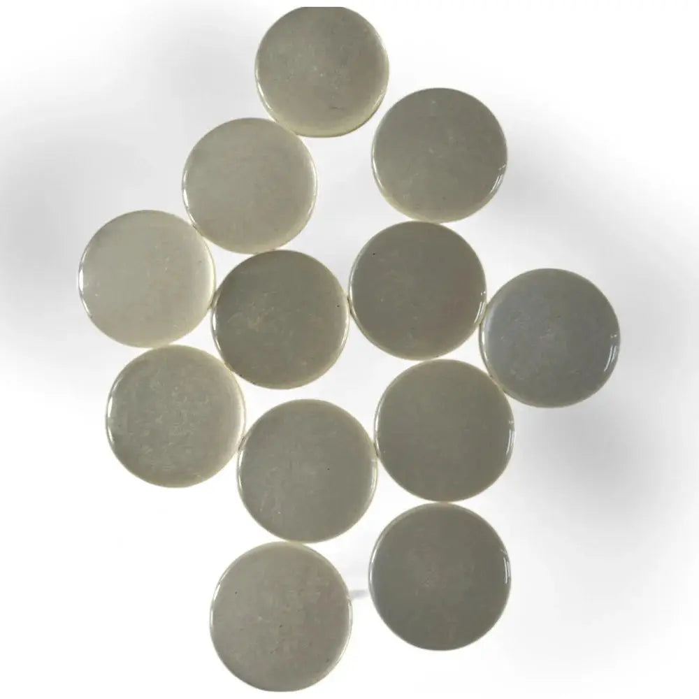 Circular, off-white, glossy buttons.