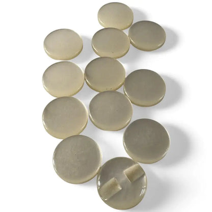 Collection of beige, round buttons.