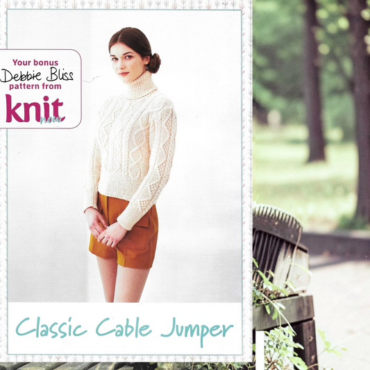 Model wearing a KnitForLess cream aran cable knit jumper with a high turtleneck, styled with mustard shorts.