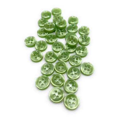 Pile of green four-hole buttons.