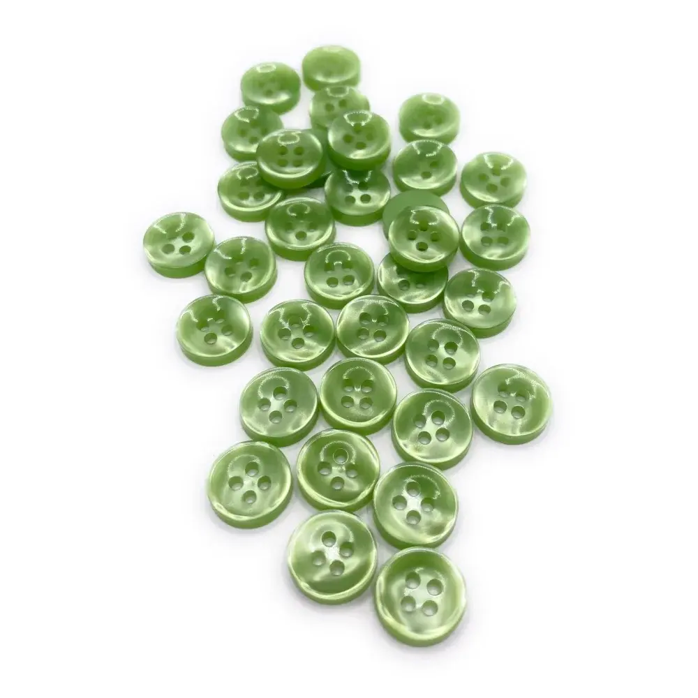 Pile of green four-hole buttons.