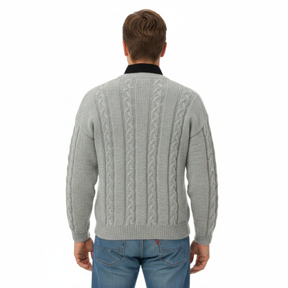 Back view of a man wearing a KnitForLess grey cable knit sweater with a textured vintage design over a black shirt.