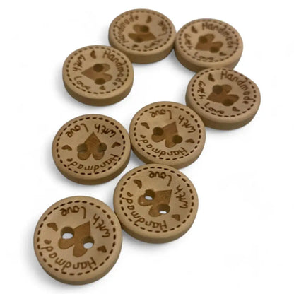 Round, wooden buttons with heart-shaped holes.
