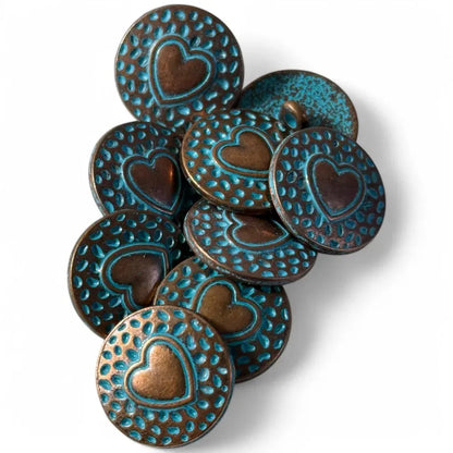 Pile of heart-stamped, turquoise-accented buttons.