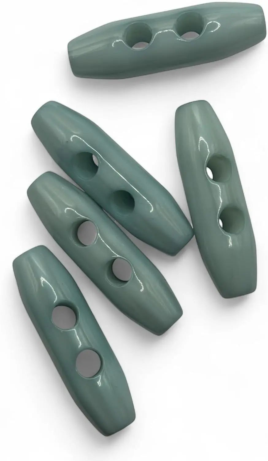 KnitForLess light blue toggle buttons with a smooth glossy finish and two holes for knitwear and coat closures.