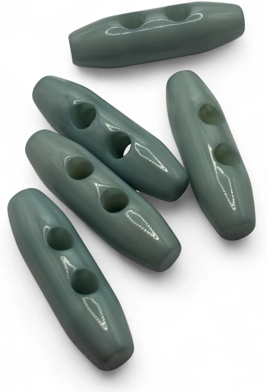 KnitForLess light blue toggle buttons with a smooth glossy finish and two holes for sewing onto knitwear and coats.
