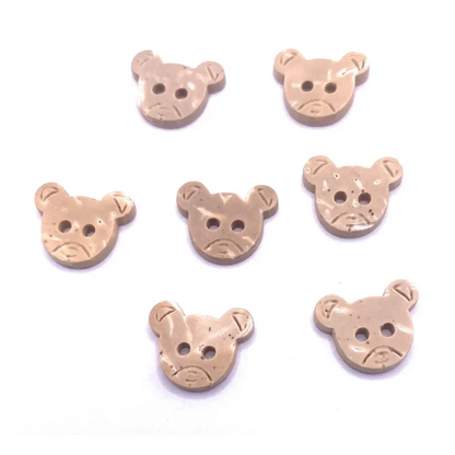 Seven tan bear-shaped buttons.