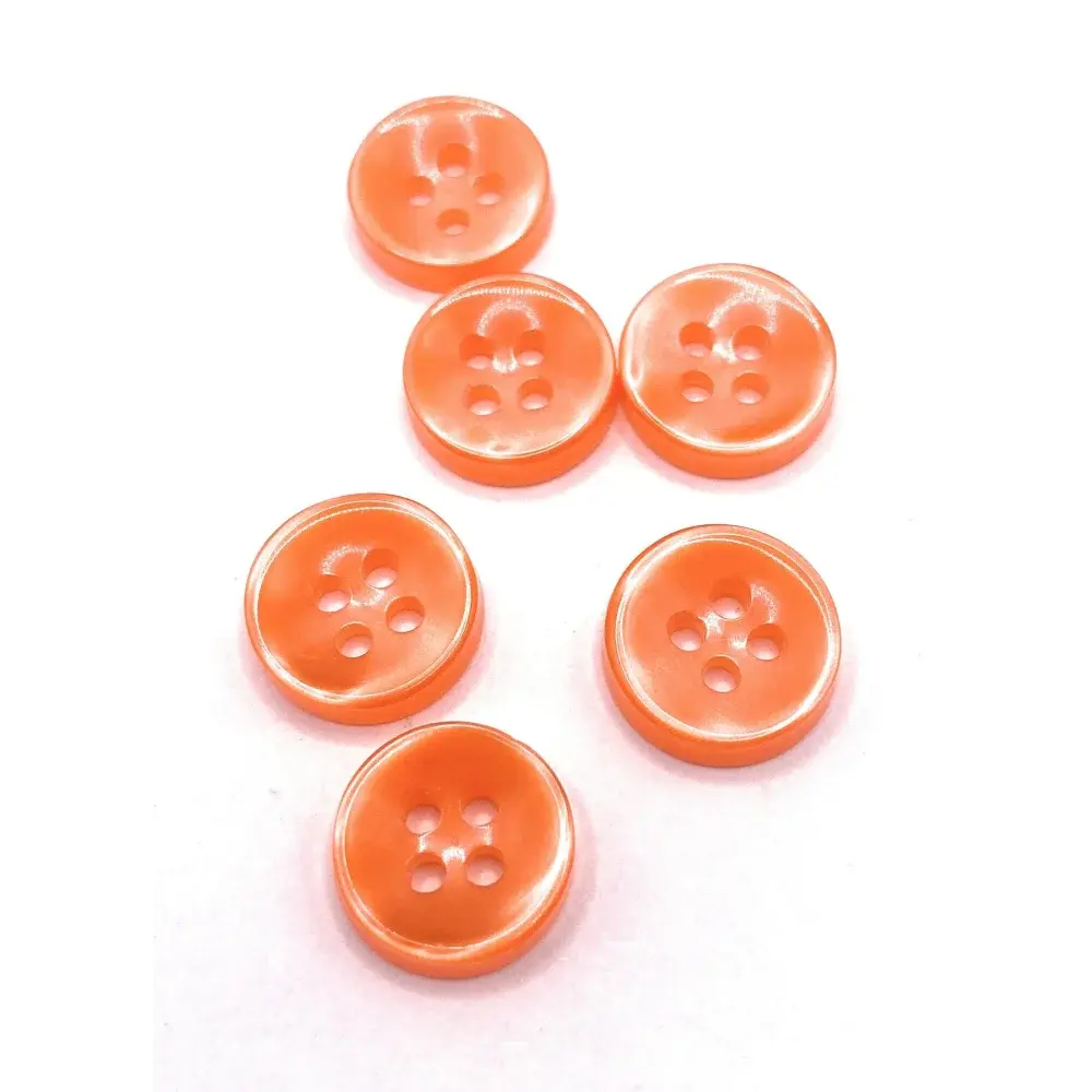 Six orange four-hole buttons.
