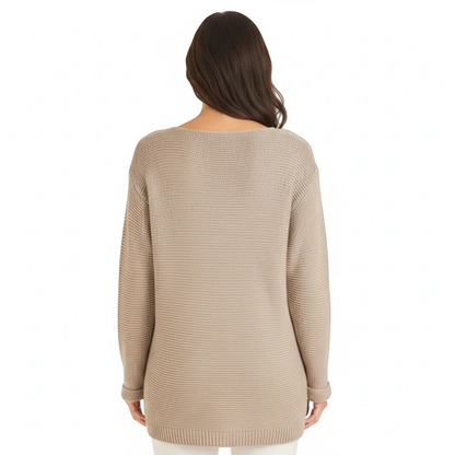 Back view of a woman wearing a KnitForLess oversized beige garter stitch sweater with a wide neck and dropped shoulders