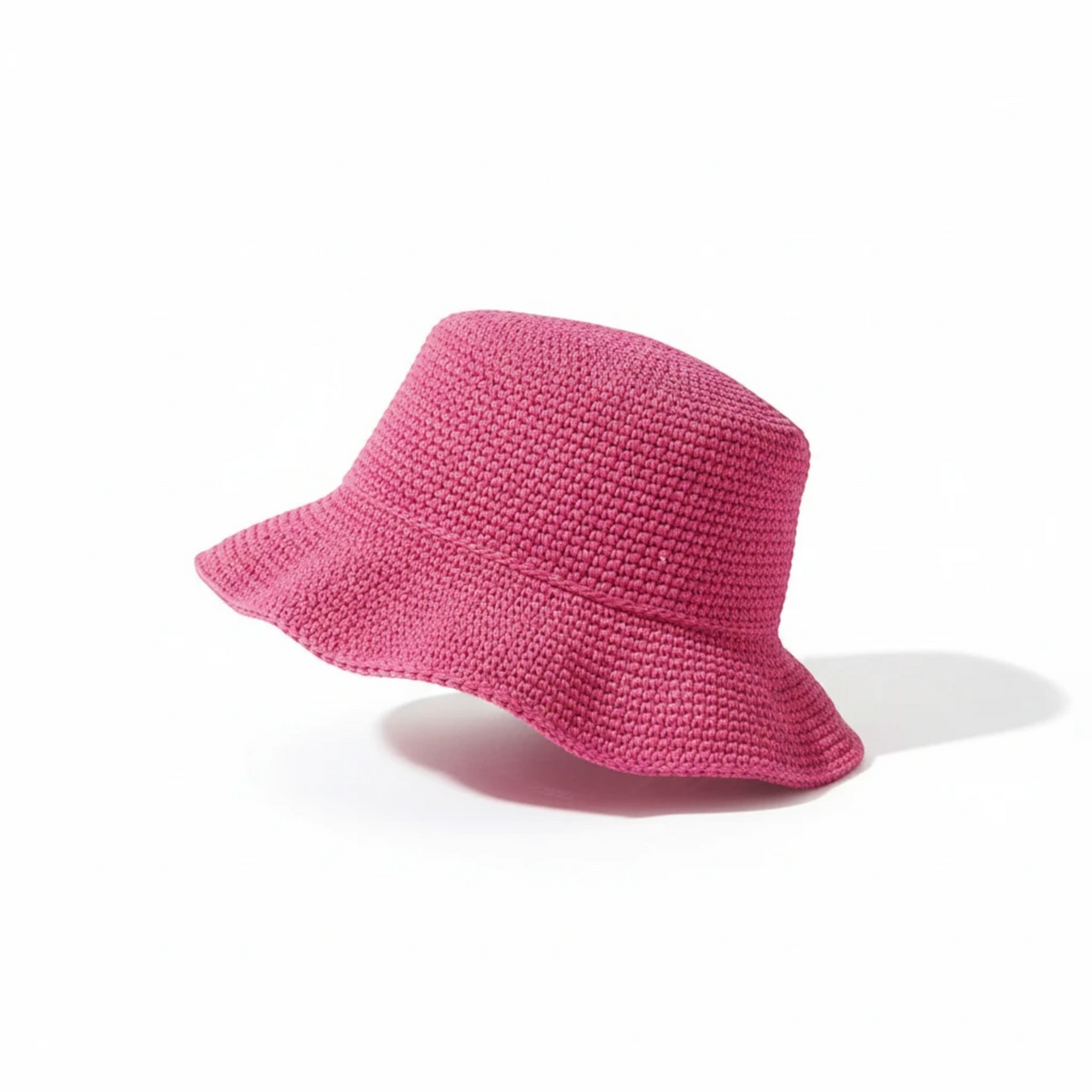 KnitForLess bright pink crocheted bucket hat with a textured stitch pattern on a clean white background.
