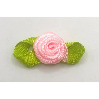 Pink ribbon rose with green ribbon leaves.