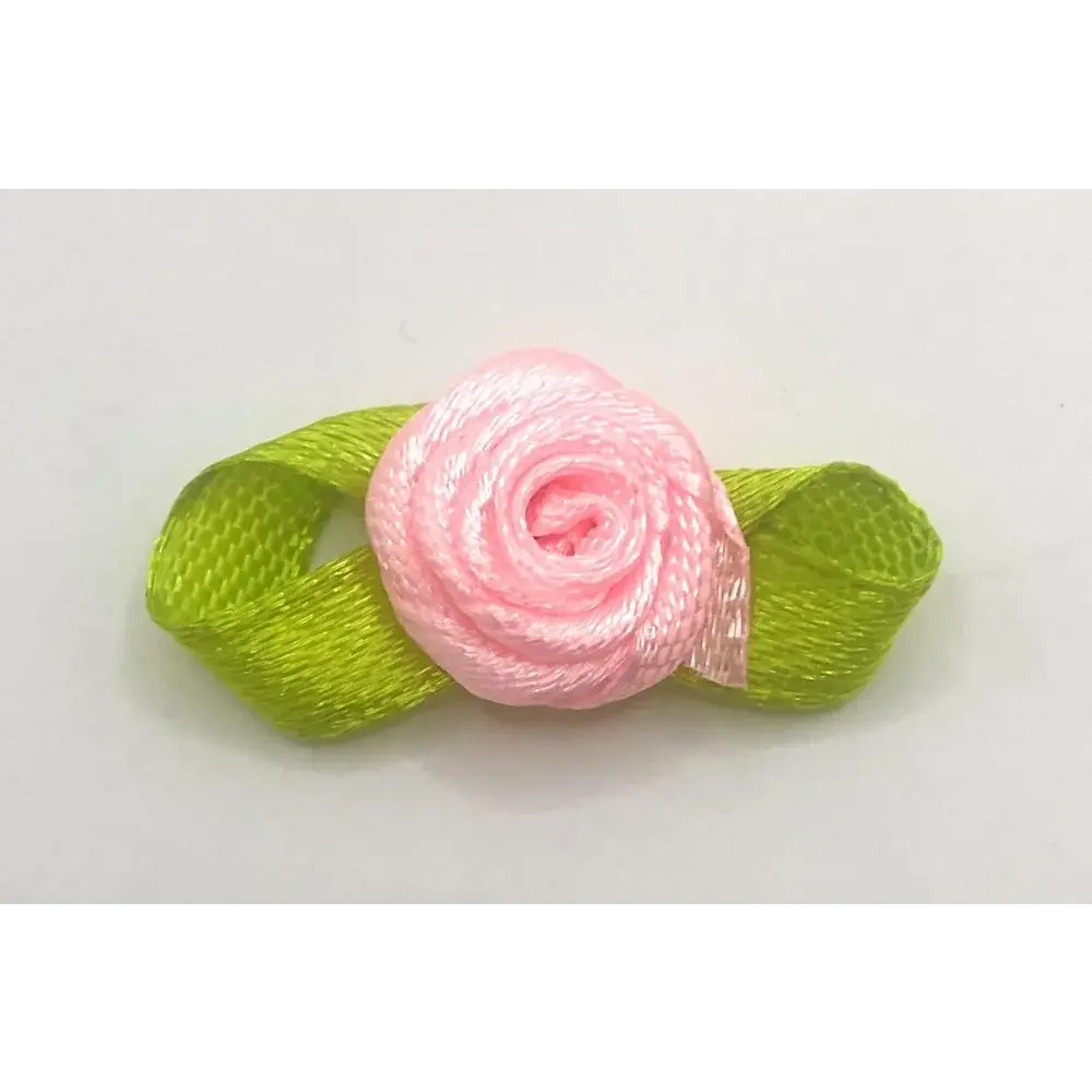 Pink ribbon rose with green ribbon leaves.