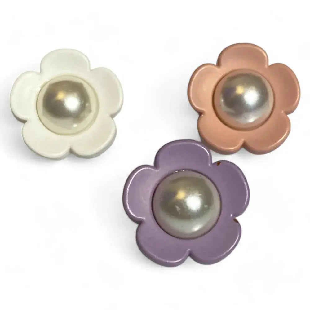 Three flower-shaped buttons with pearl centers.