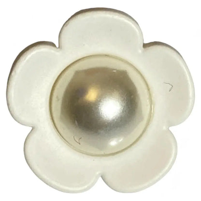 White flower-shaped button with pearl center.