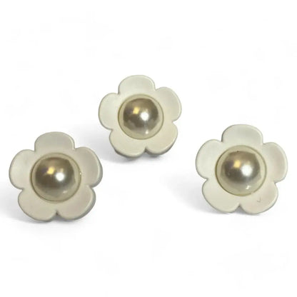 Three flower-shaped buttons with pearl centers.