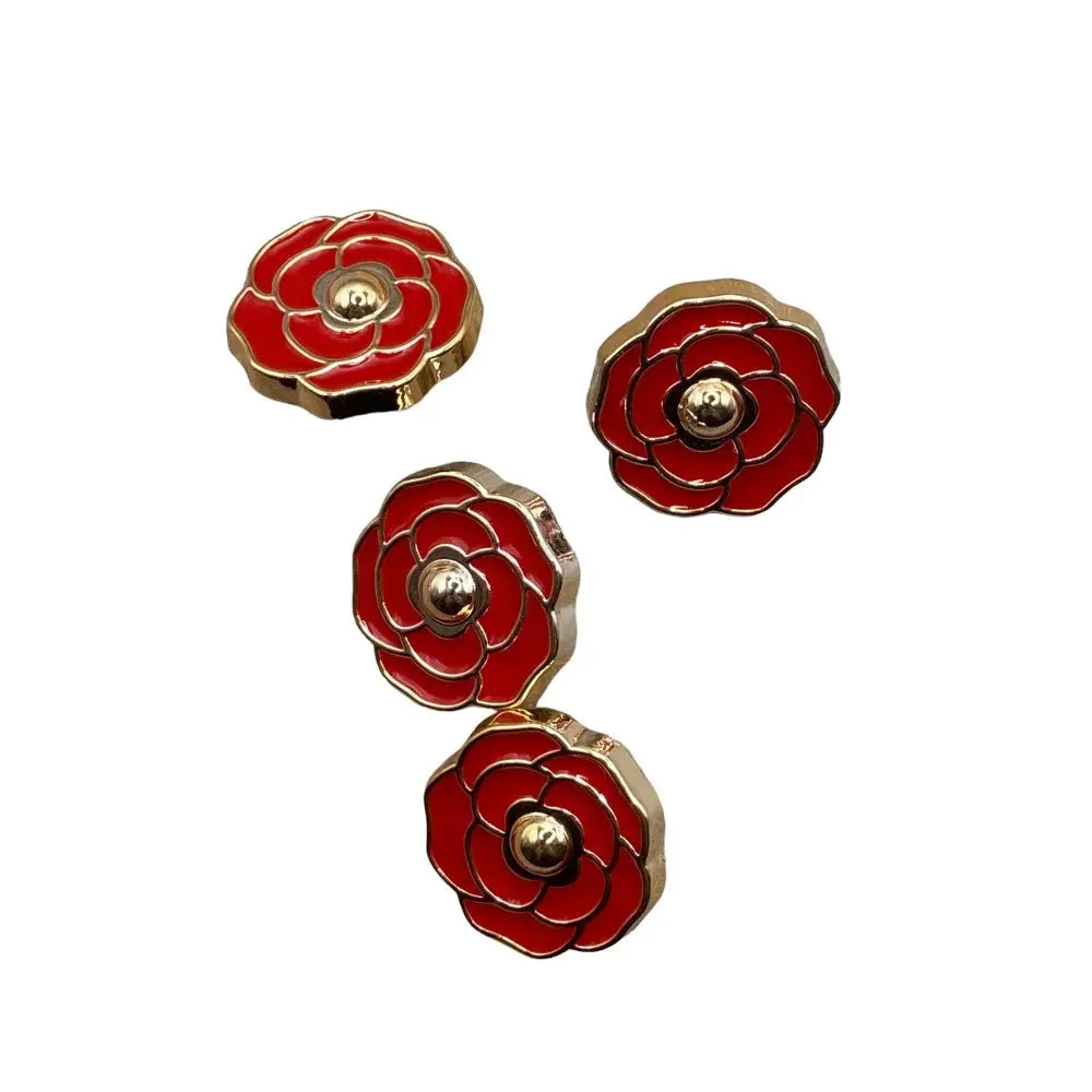 Four red and gold flower-shaped buttons.