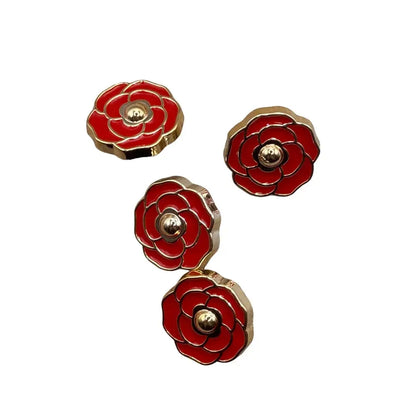 Four red and gold flower-shaped buttons.
