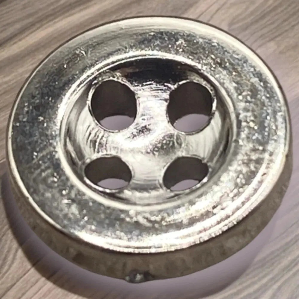 Shiny silver four-hole button.
