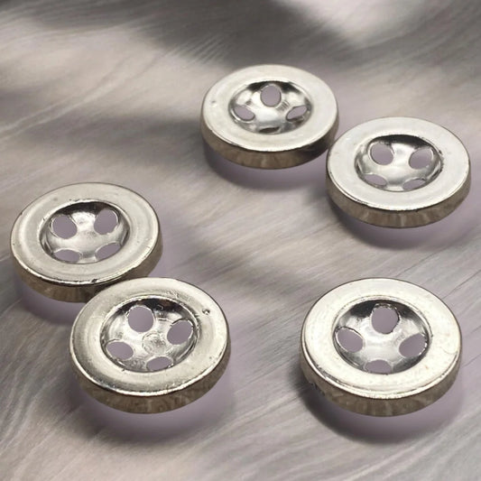 Silver metal buttons with multiple holes.