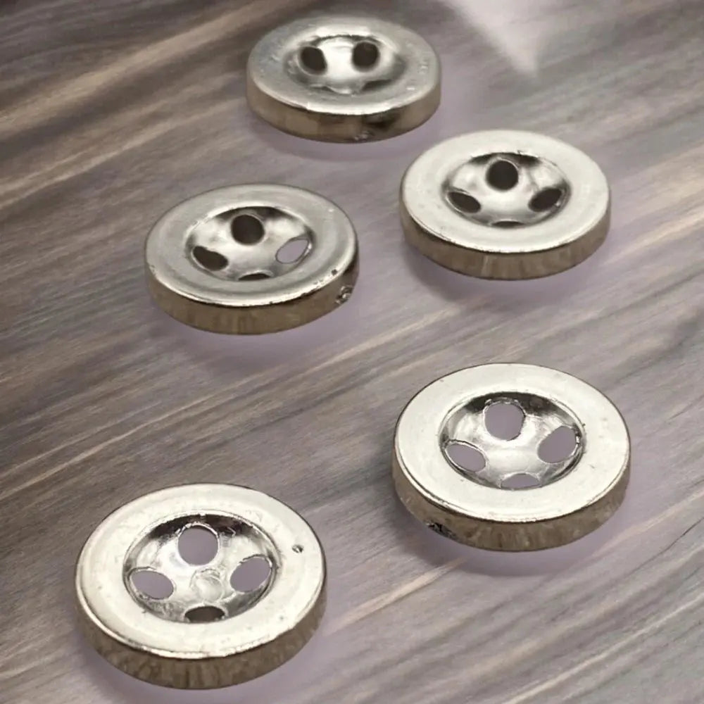 Shiny silver buttons with multiple holes.