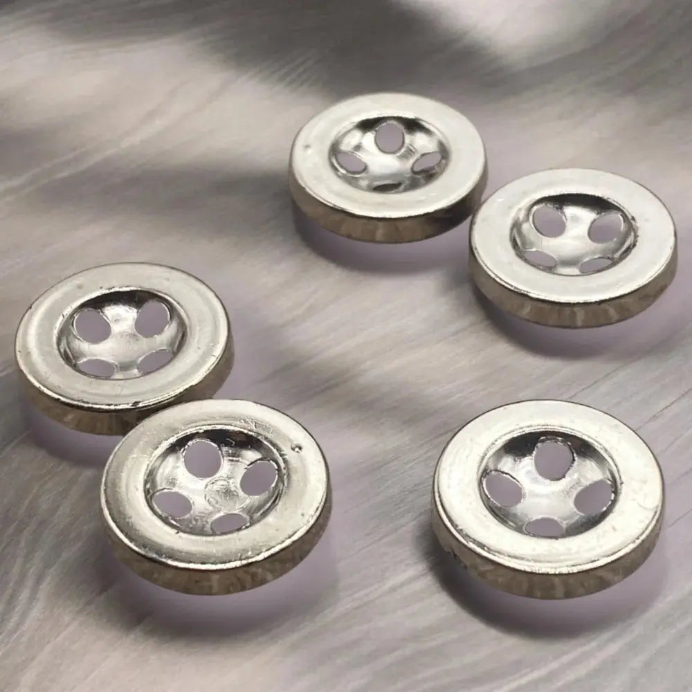 Silver metal buttons with multiple holes.