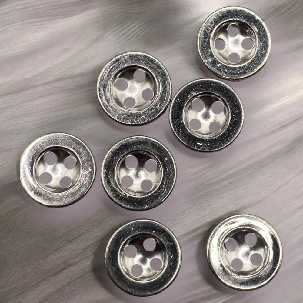Silver four-hole buttons.