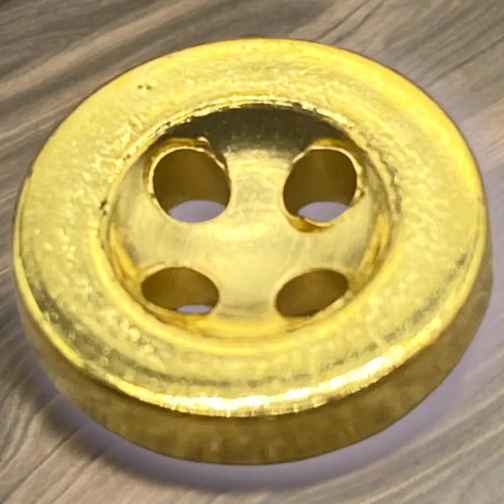 Gold-colored four-hole button.