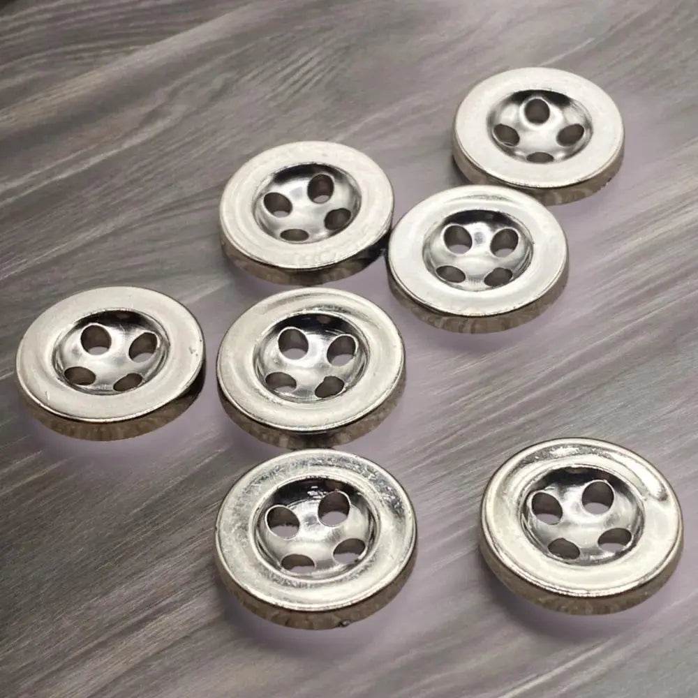 Shiny metal buttons with holes.