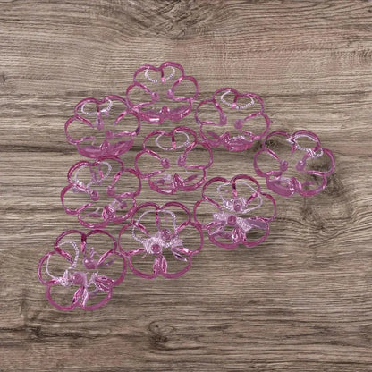 Pink flower-shaped plastic coasters.