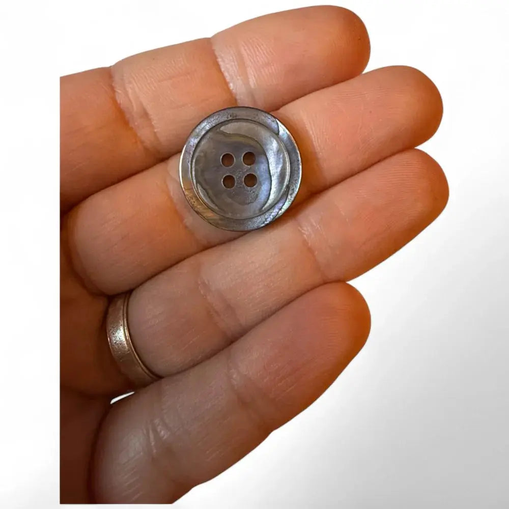Mother-of-pearl four-hole button.