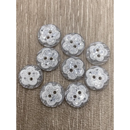 Group of flower-shaped, glittery buttons.