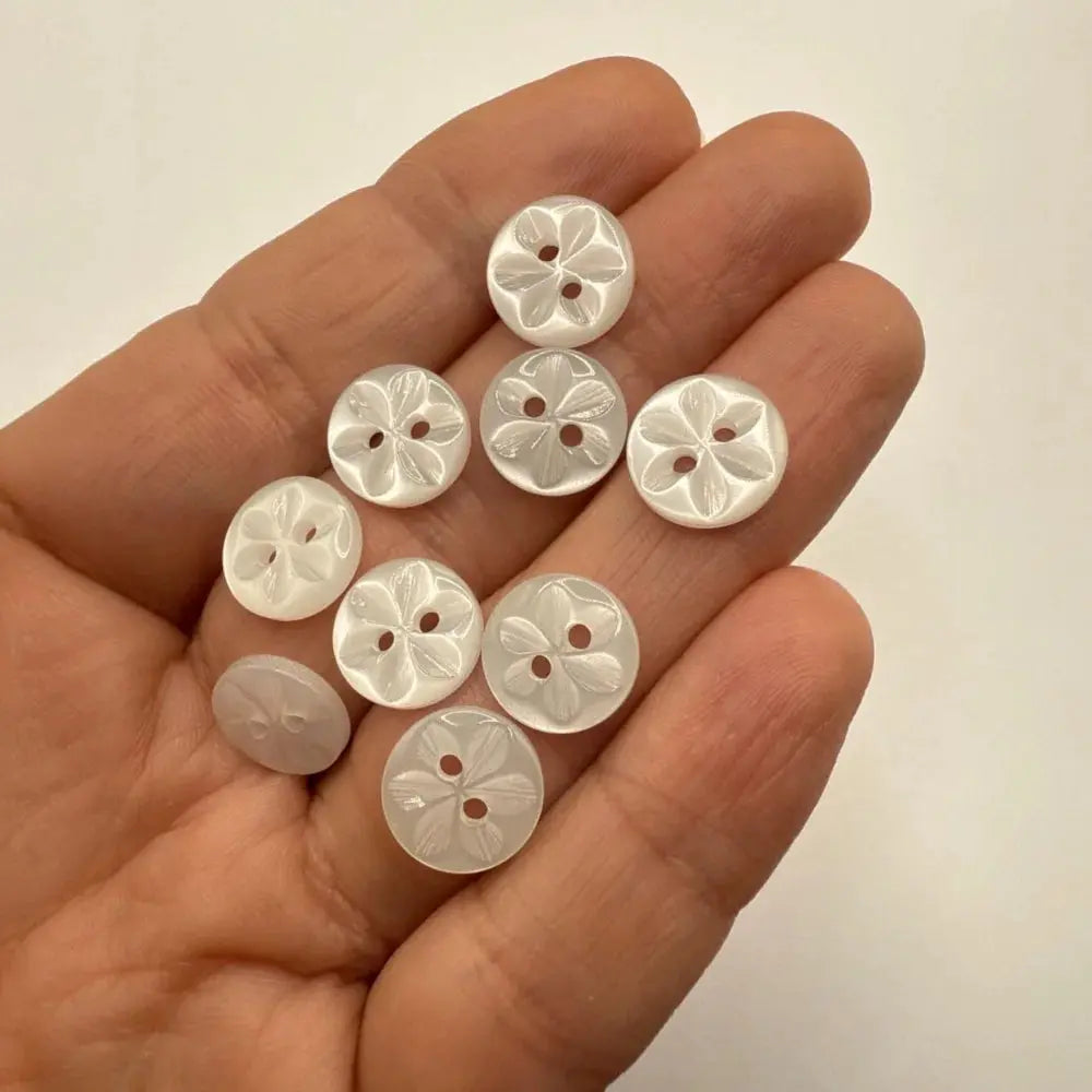 Handful of flower-carved buttons.