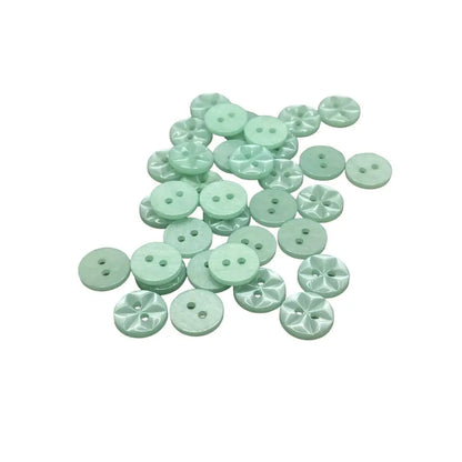 Pile of light green sewing buttons.