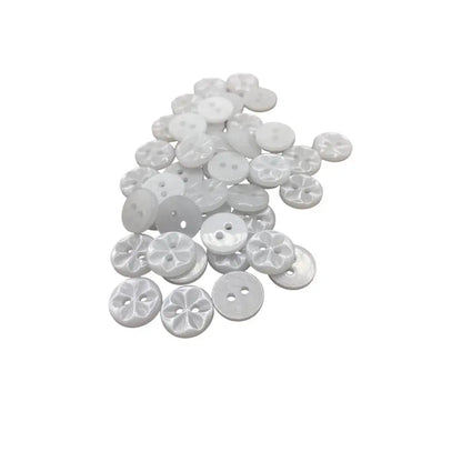 Pile of white sewing buttons.