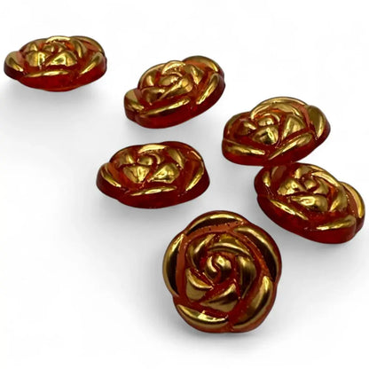 Six rose-shaped, red and gold buttons.