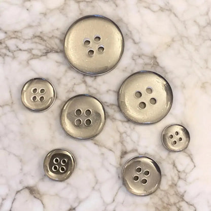 Silver-colored sewing buttons.