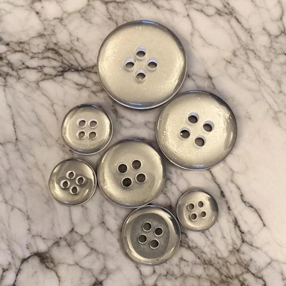 Silver-colored, four-hole buttons.