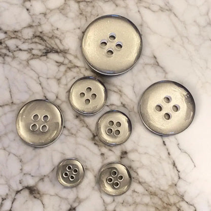 Silver four-hole buttons.
