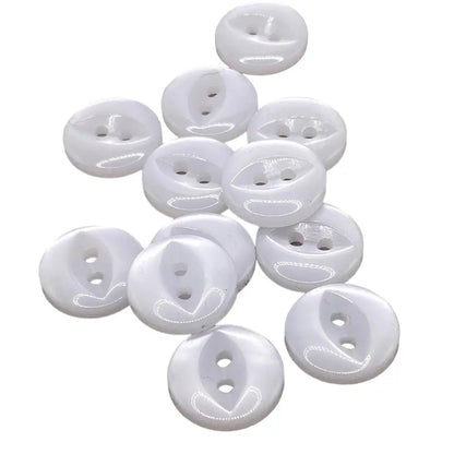 Pile of glossy white two-hole buttons.