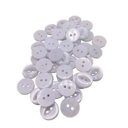 Pile of white, two-hole buttons.