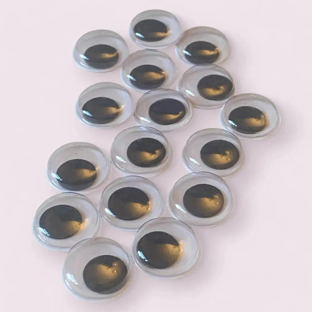 Glassy craft eyes with black pupils.