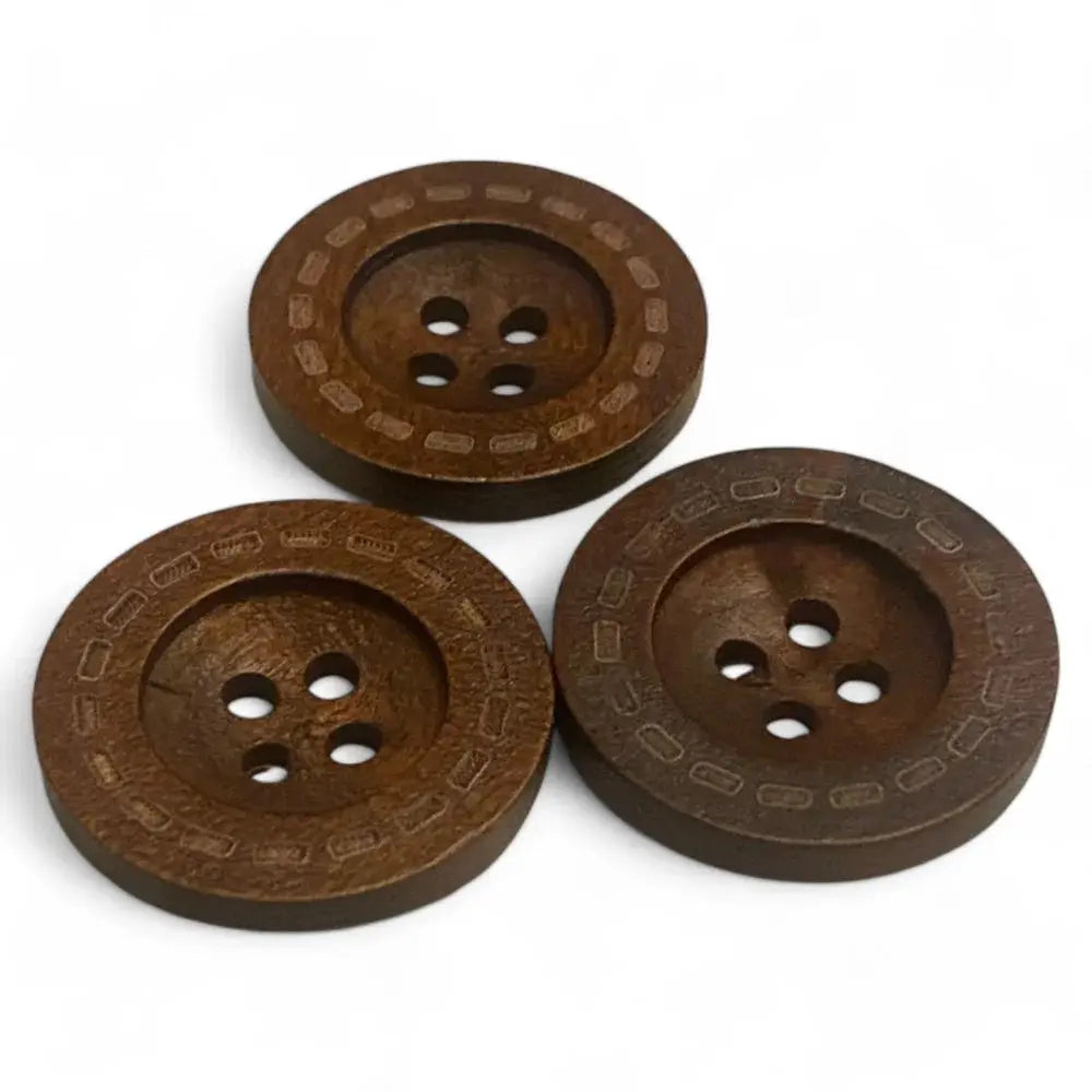 Three brown, four-hole wooden buttons.